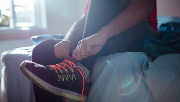 Man putting on his running shoes.