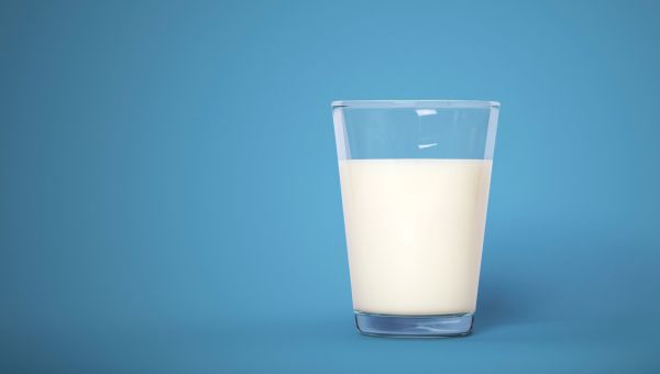 Glass of milk sitting in an empty room