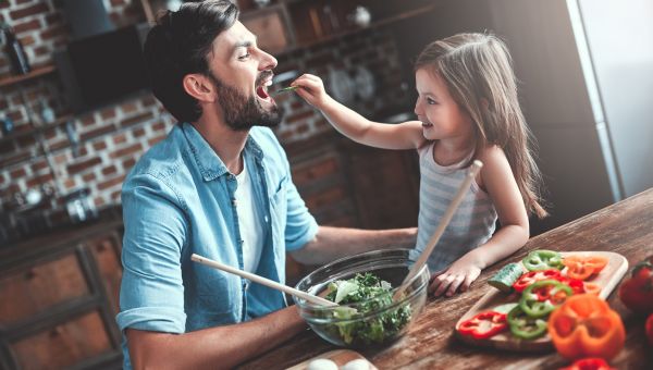 daughter feeding her dad