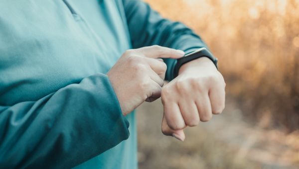person looks at their smartwatch