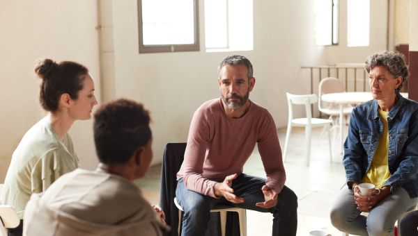 members of a support group gather to help each other