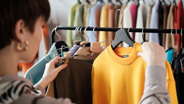 person examining clothes on a rack