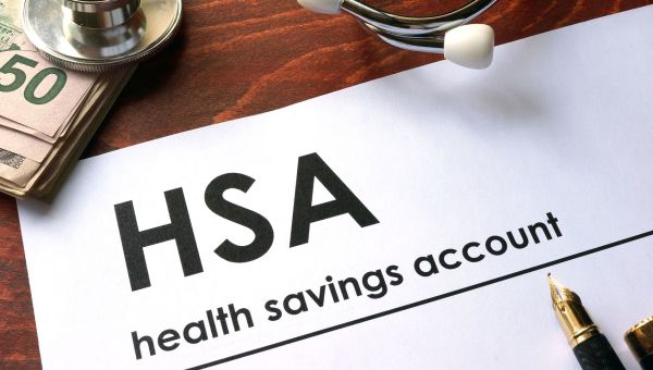 HSA documentation on a wooden table to help with choosing health insurance at work
