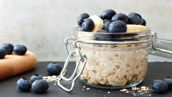 Oatmeal in a jar with banana and blueberries.