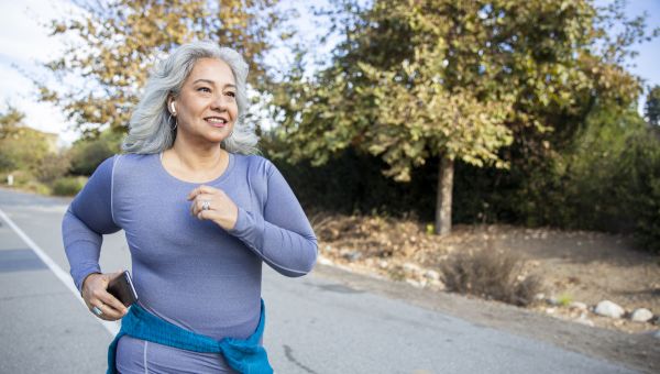 happy mature woman walking outside