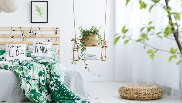 A serene bedroom filled with leafy, natural decor.