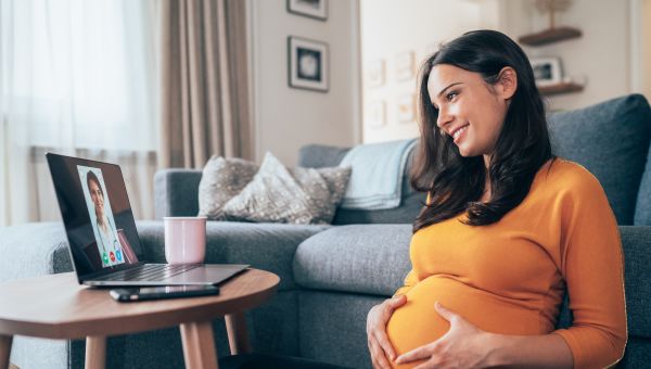 a pregnant woman as a telehealth consultation with her healthcare provider