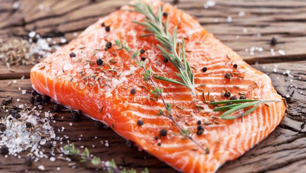 a slice of salmon seasoned with salt, pepper, rosemary, and thyme