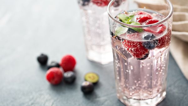 glass of sparkling water with berries