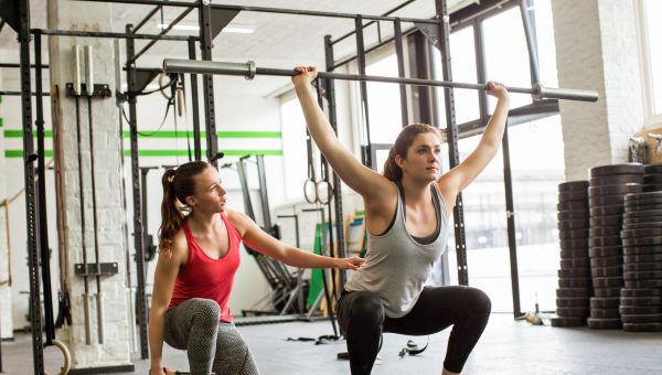 trainer helping workout