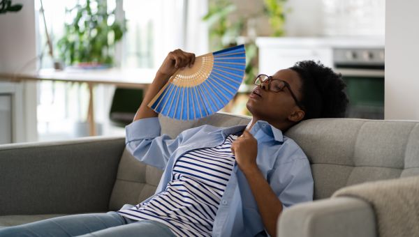 woman on couch sweating