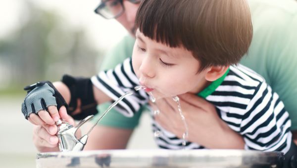 kid drinking from water fountain