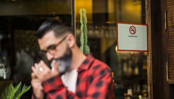 Man smoking outside a bar