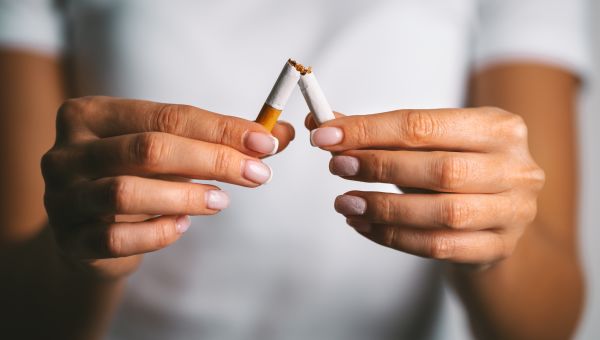 woman breaks a cigarette in half