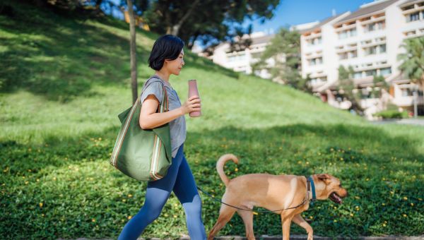 woman walking dog in park