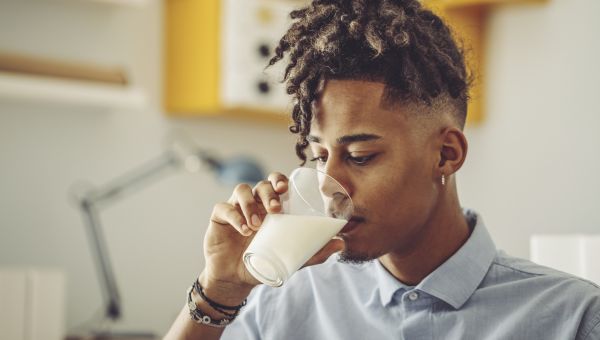 a young man drinking milk