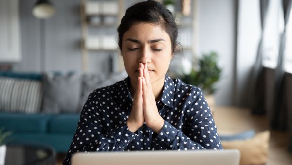 woman taking a deep breath at work