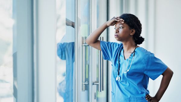 frustrated nurse leaning on window