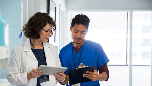 young male nurse talking with female doctor