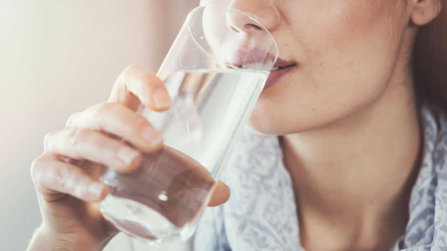 woman drinking a glass of water