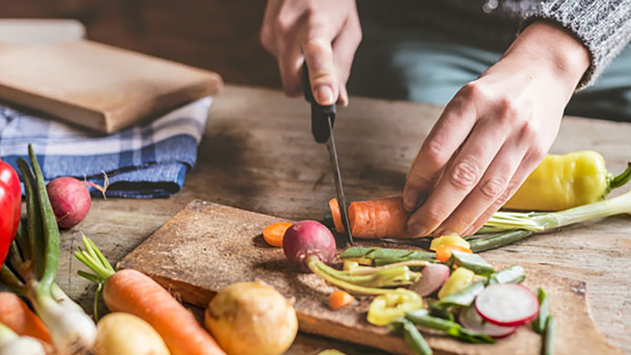 Closeup of vegetables being chopped.