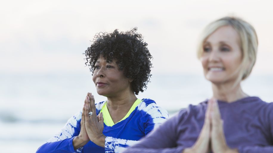 Mature senior women tai chi on beach