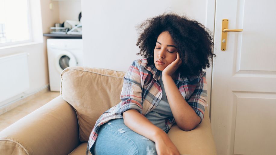 Tired woman sleeping on couch