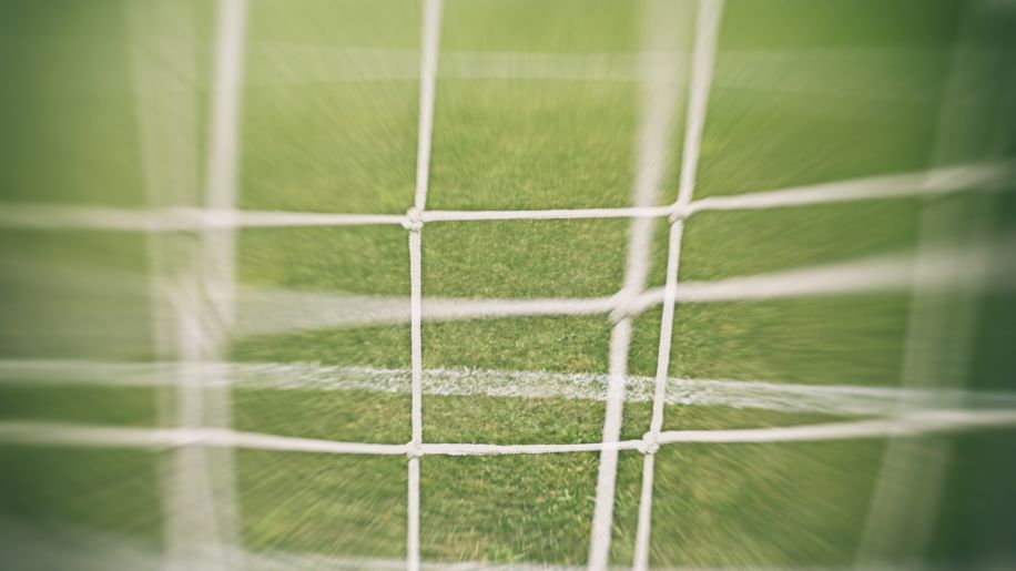 Blurry view of a soccer net.