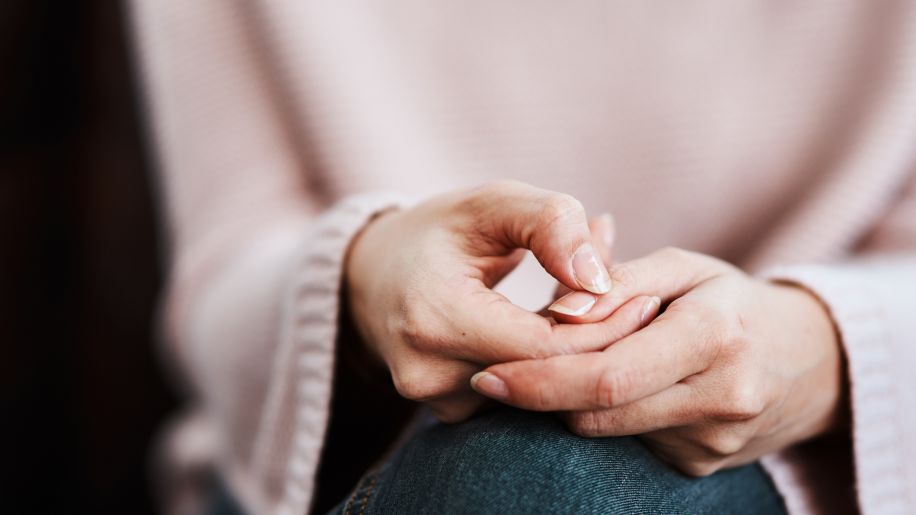 woman with anxiety wringing her hands
