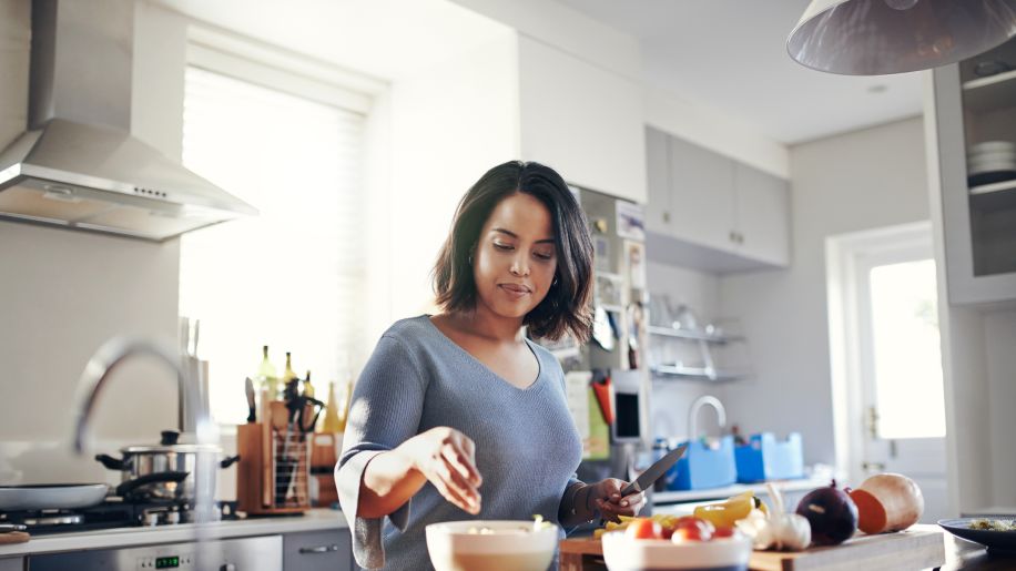 woman cutting up vegetables in the kitchen