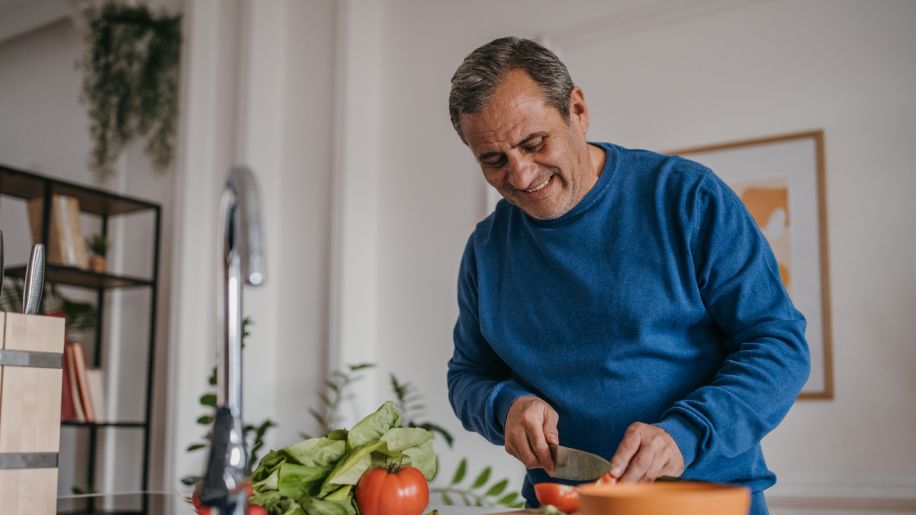 Mature man cooking healthy dinner