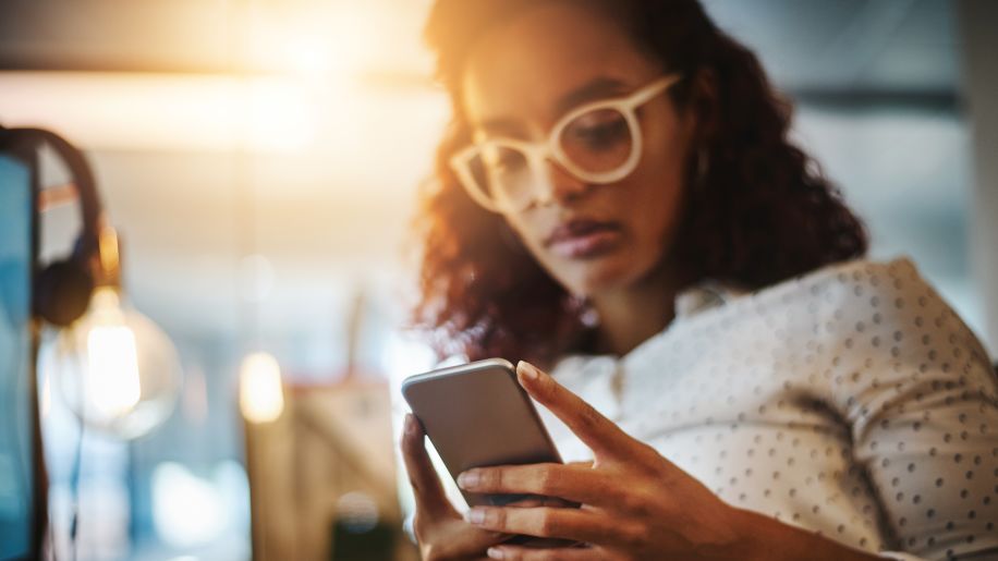 Woman looks at a video magnifier on phone