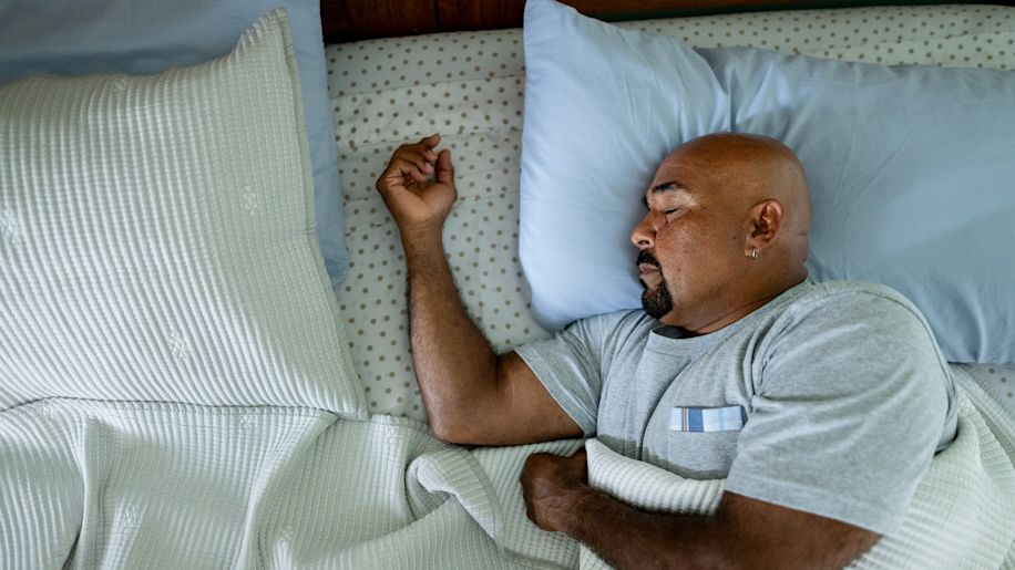 middle-aged bald man sleeping soundly