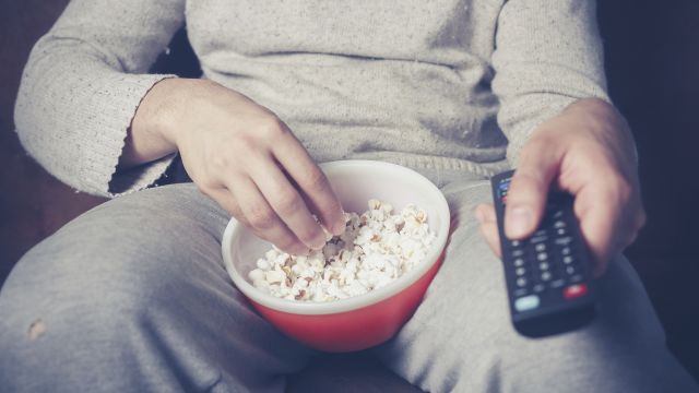 close up of belly, popcorn and remote control, gray sweats