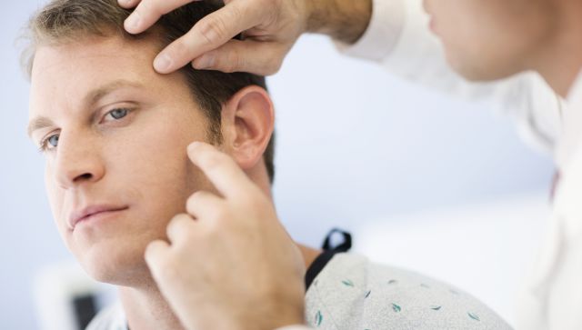 Doctor Examining Patient's Face