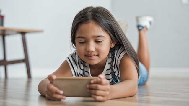young girl playing with smart phone