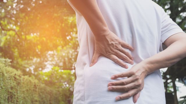 Man experiencing back pain and muscle pain
