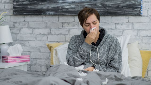 Person with a cold sitting in bed