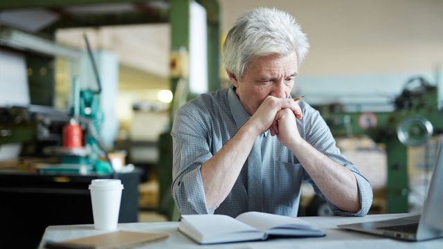 A pensive older man wonders if his forgetfulness and cognitive impairment are signs of early onset Alzheimer’s disease.