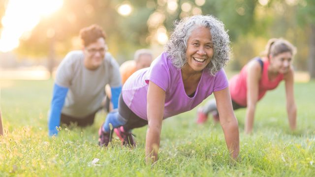 woman doing plank in the grass