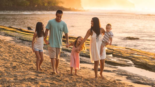 family walking on the beach in hawaii