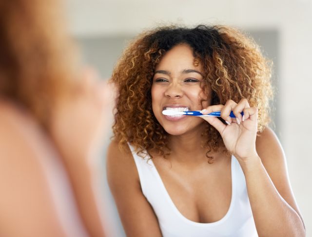 woman brushing teeth