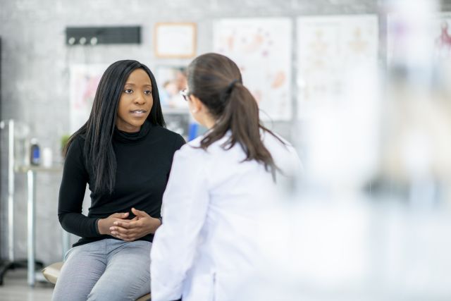 Young woman speaking with female OBGYN