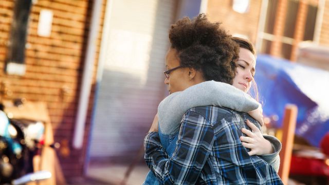 Two women hug after learning how to forgive someone who hurt you. They also know what forgiveness is—and what it isn't.