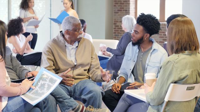 A group of people chatting in a circle.