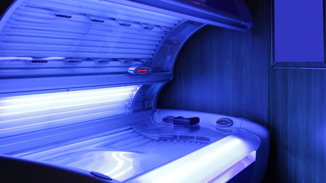 Woman using indoor tanning bed