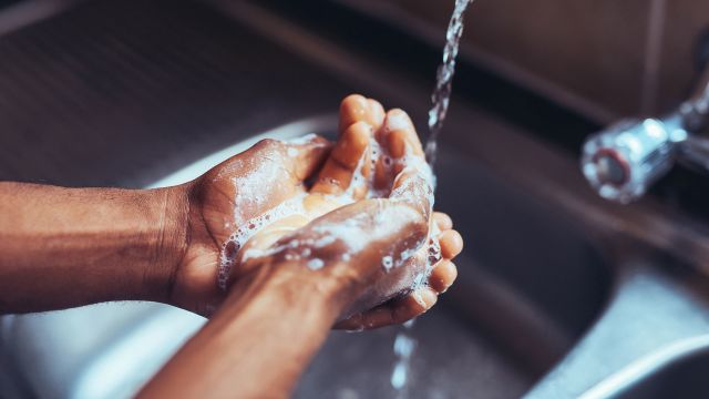 washing hands over sink