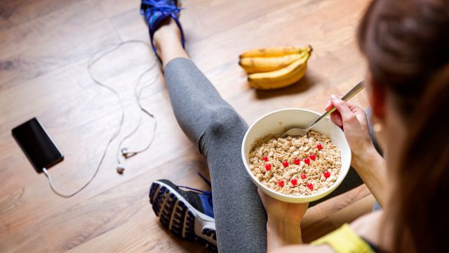 young woman eating oatmeal