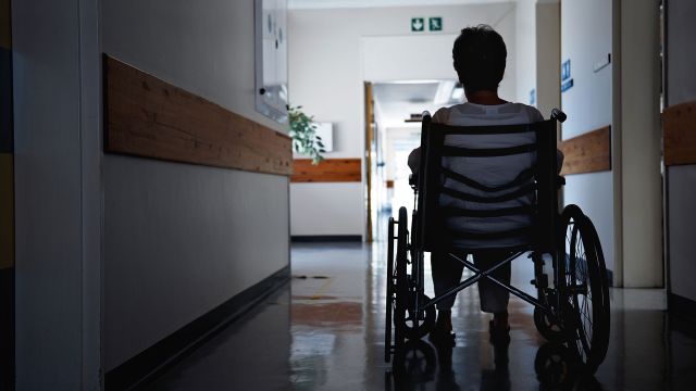 Man in wheelchair inside a hospital.