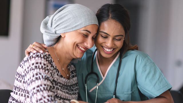 A woman living with ovarian cancer shares a moment with her doctor.